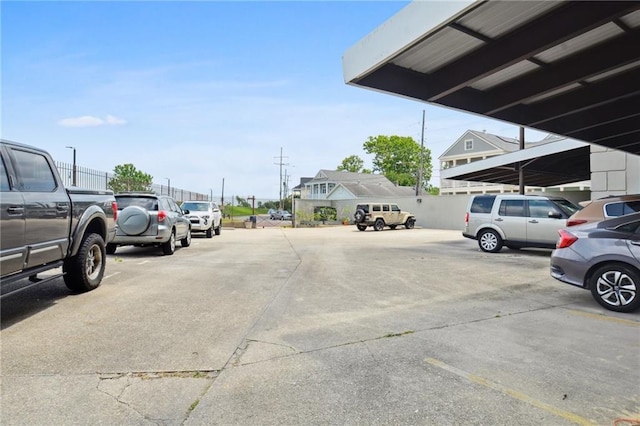 view of parking / parking lot featuring a carport