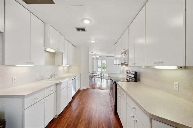 kitchen with white cabinets, dark hardwood / wood-style floors, white appliances, and sink