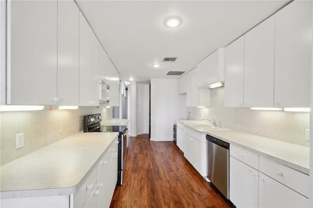 kitchen with white cabinets, dark wood-type flooring, black electric range oven, and stainless steel dishwasher