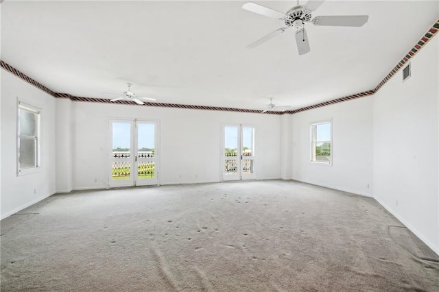 carpeted spare room with ceiling fan