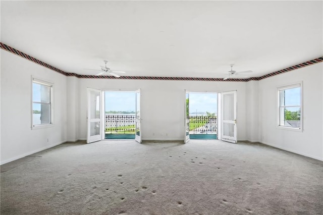 empty room with ceiling fan and carpet floors