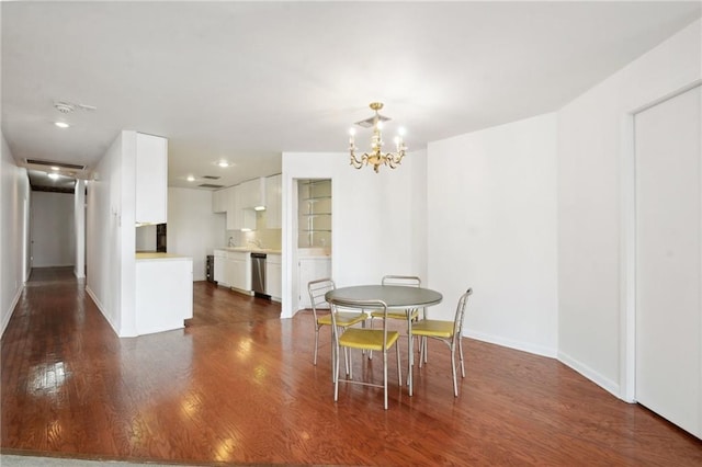 dining area featuring dark hardwood / wood-style floors and an inviting chandelier