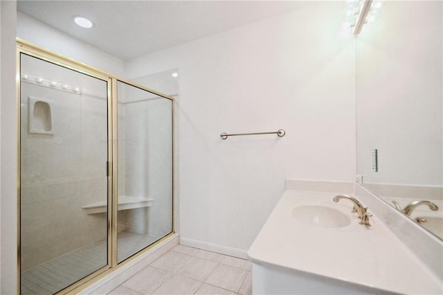 bathroom with tile patterned flooring, vanity, and a shower with shower door