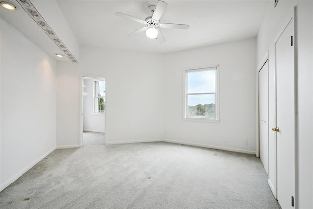 unfurnished bedroom featuring ceiling fan and light carpet