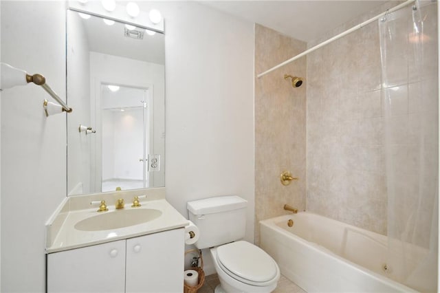 full bathroom featuring vanity, tiled shower / bath combo, and toilet