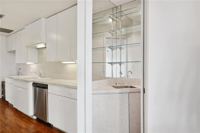 bar featuring sink, white cabinets, stainless steel dishwasher, and dark hardwood / wood-style floors