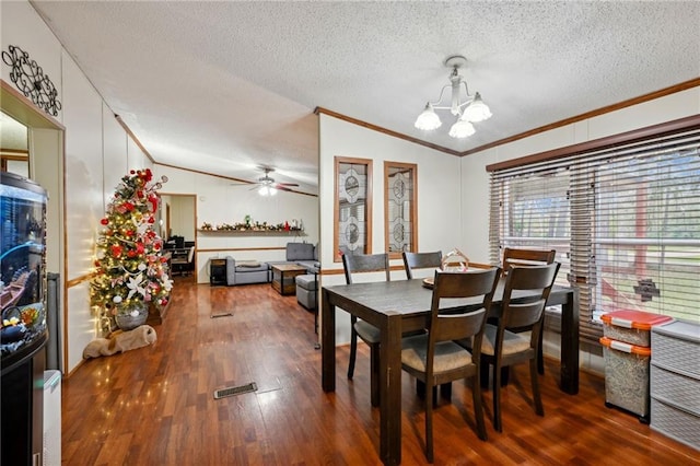 dining area with hardwood / wood-style floors, ceiling fan with notable chandelier, ornamental molding, and lofted ceiling