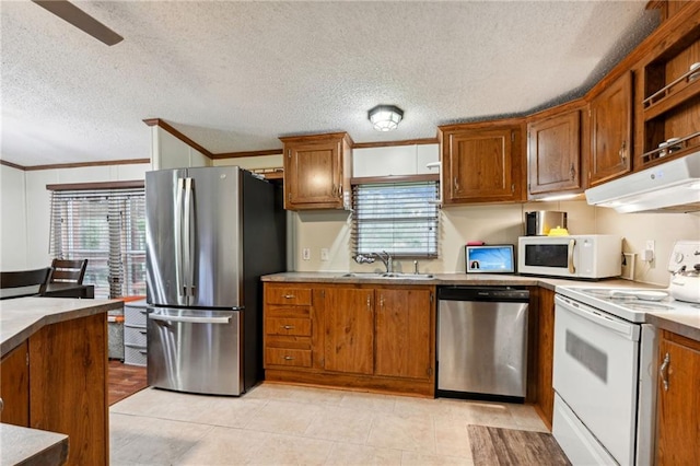 kitchen featuring a textured ceiling, ornamental molding, sink, and appliances with stainless steel finishes