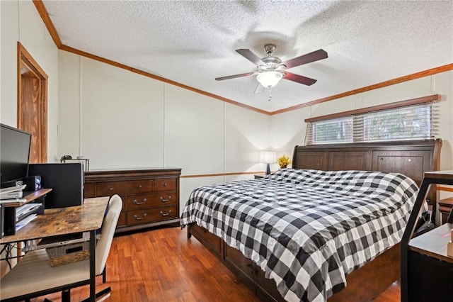 bedroom with a textured ceiling, ceiling fan, crown molding, and dark wood-type flooring