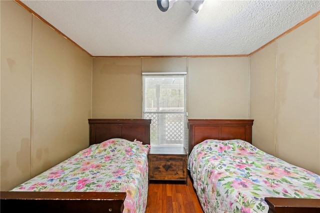 bedroom featuring hardwood / wood-style floors and a textured ceiling