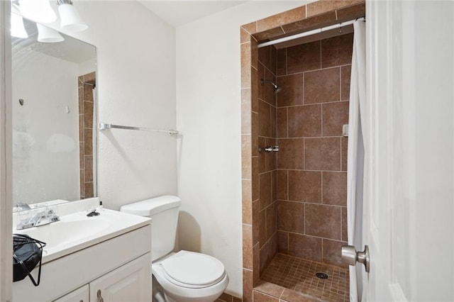 full bathroom featuring toilet, a shower stall, and vanity