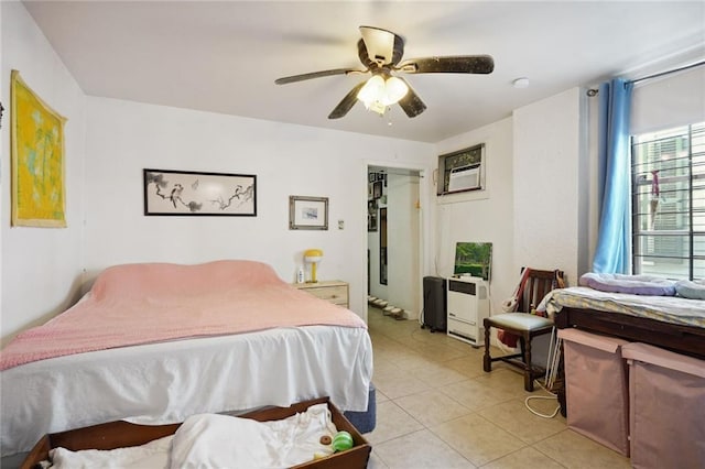 bedroom with light tile patterned floors, a wall mounted AC, and a ceiling fan