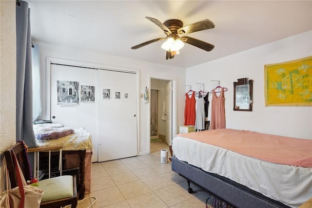 bedroom featuring light tile patterned floors, ceiling fan, and ensuite bath