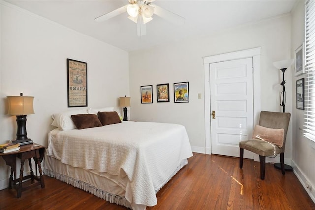 bedroom with dark wood-style flooring, a ceiling fan, and baseboards