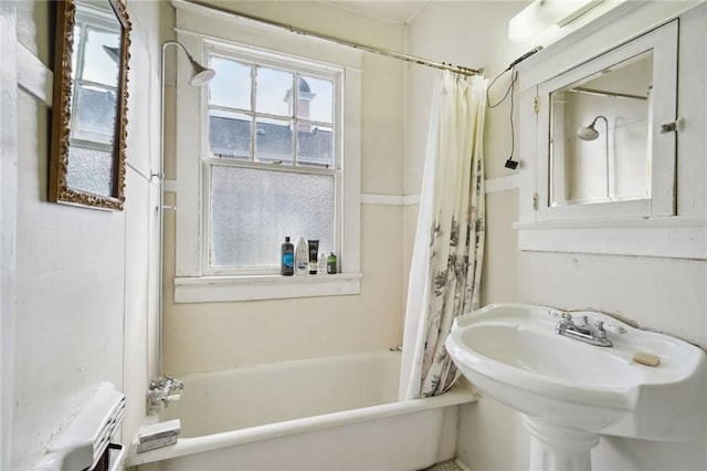 full bathroom featuring shower / tub combo with curtain and a sink