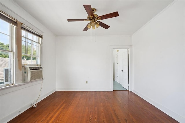 unfurnished room with ornamental molding, ceiling fan, wood finished floors, cooling unit, and baseboards