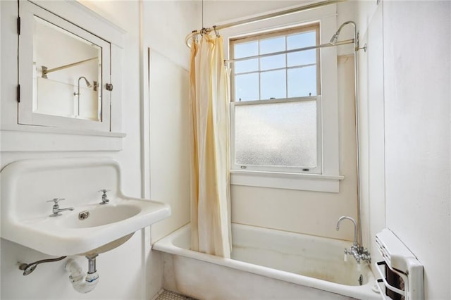 full bathroom featuring radiator and shower / tub combo with curtain