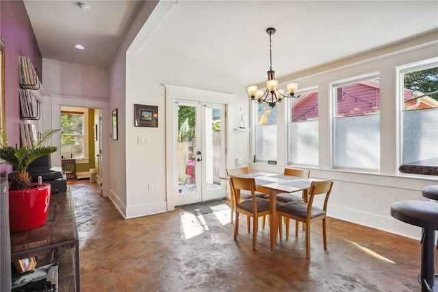 dining space featuring a notable chandelier and french doors