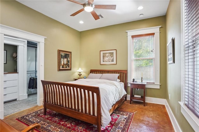 bedroom featuring carpet flooring, a walk in closet, a closet, and ceiling fan