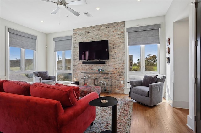 living room featuring light hardwood / wood-style flooring and ceiling fan