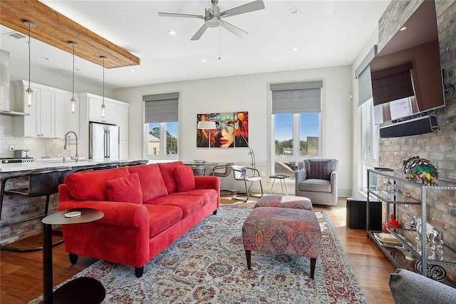 living room featuring light hardwood / wood-style floors and ceiling fan