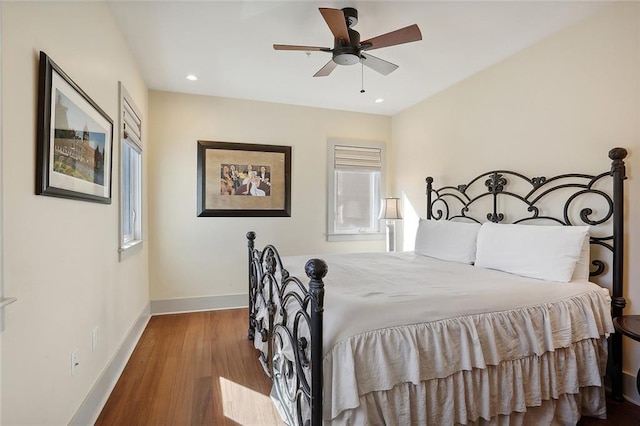 bedroom with ceiling fan, light hardwood / wood-style floors, and multiple windows