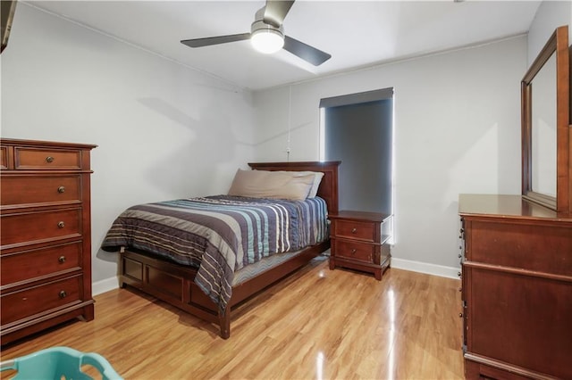 bedroom with ceiling fan and light hardwood / wood-style floors