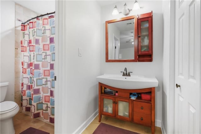 bathroom with vanity, toilet, and walk in shower