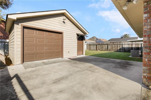 garage featuring a yard and central AC