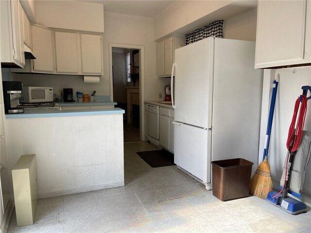 49 Papworth Ave, Metairie, LA 70005 - kitchen with white cabinets, white appliances, kitchen peninsula, and ornamental molding