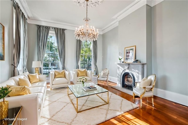 sitting room with crown molding, a chandelier, and wood-type flooring