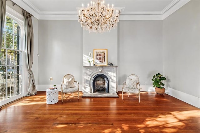 unfurnished room featuring ornamental molding, hardwood / wood-style flooring, and a notable chandelier