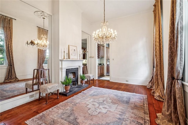 living area with dark hardwood / wood-style flooring and a chandelier