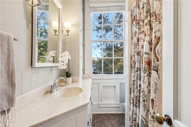 bathroom with tile patterned flooring, vanity, and a notable chandelier