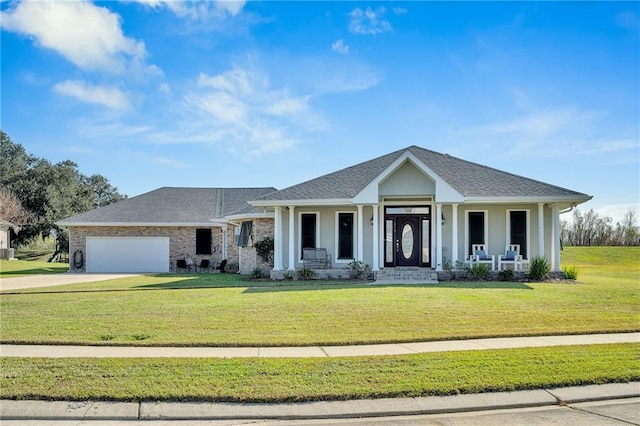 view of front of home featuring a porch, a front yard, and a garage