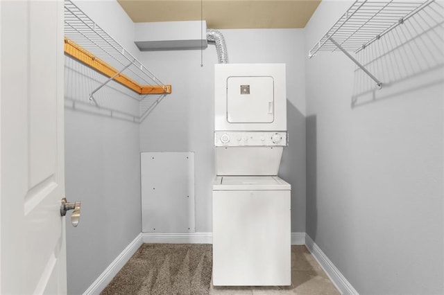 washroom featuring carpet flooring and stacked washer / drying machine