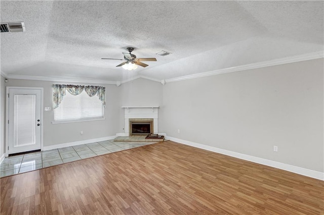 unfurnished living room with ceiling fan, light hardwood / wood-style floors, lofted ceiling, and crown molding