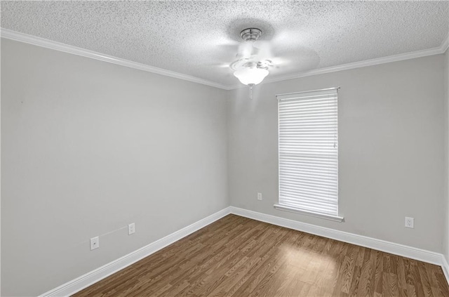 empty room featuring ceiling fan, hardwood / wood-style floors, a textured ceiling, and ornamental molding