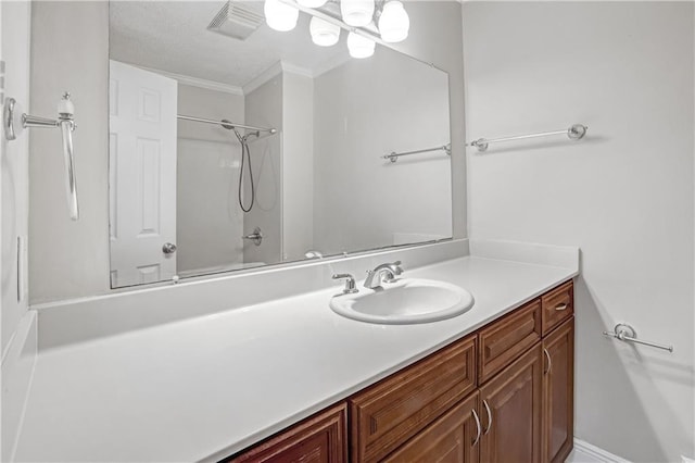 bathroom with crown molding and vanity