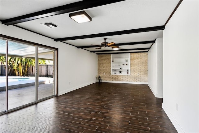 unfurnished room featuring beamed ceiling, ceiling fan, and brick wall