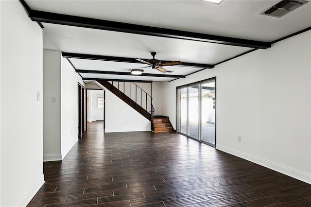 spare room featuring ceiling fan and beamed ceiling