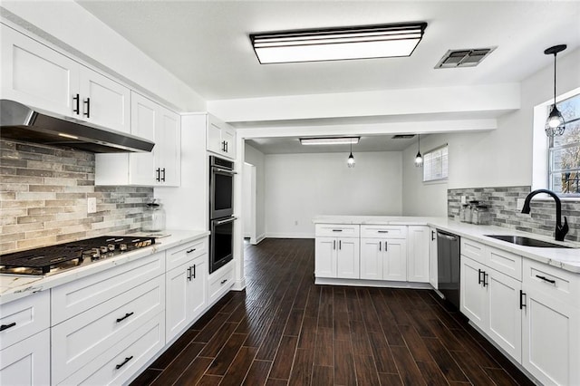 kitchen featuring sink, hanging light fixtures, light stone countertops, white cabinetry, and stainless steel appliances