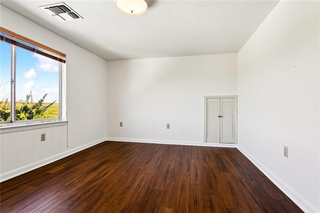 spare room featuring dark wood-type flooring