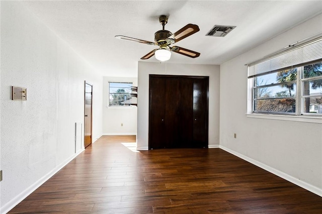 unfurnished bedroom featuring dark hardwood / wood-style flooring and ceiling fan