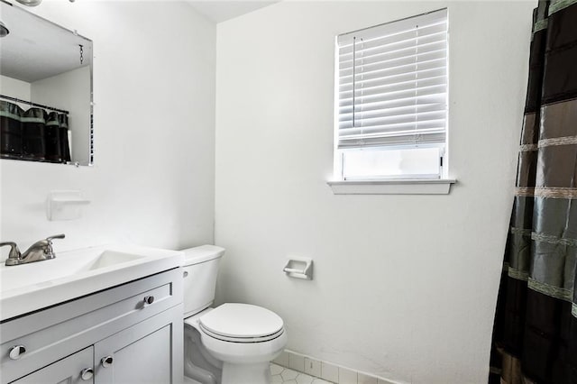 bathroom featuring walk in shower, tile patterned flooring, vanity, and toilet