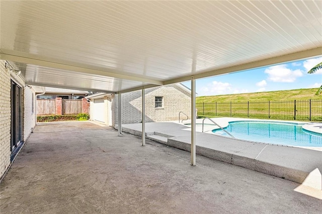 view of pool featuring a patio and a rural view