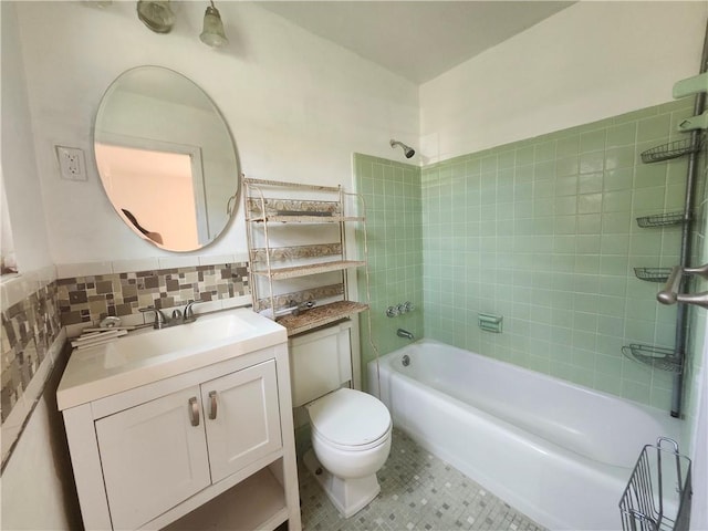 full bathroom with vanity, toilet, and tiled shower / bath