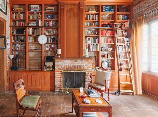 sitting room featuring a brick fireplace