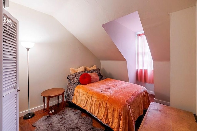 bedroom featuring hardwood / wood-style flooring and vaulted ceiling