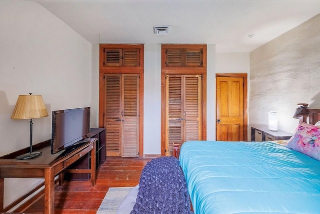 bedroom with dark hardwood / wood-style floors